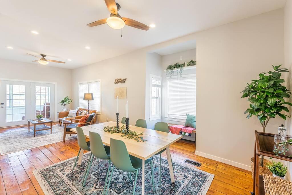 a living room with a dining room table and chairs at Modern, Charming Bungalow by the Park in Saint Paul