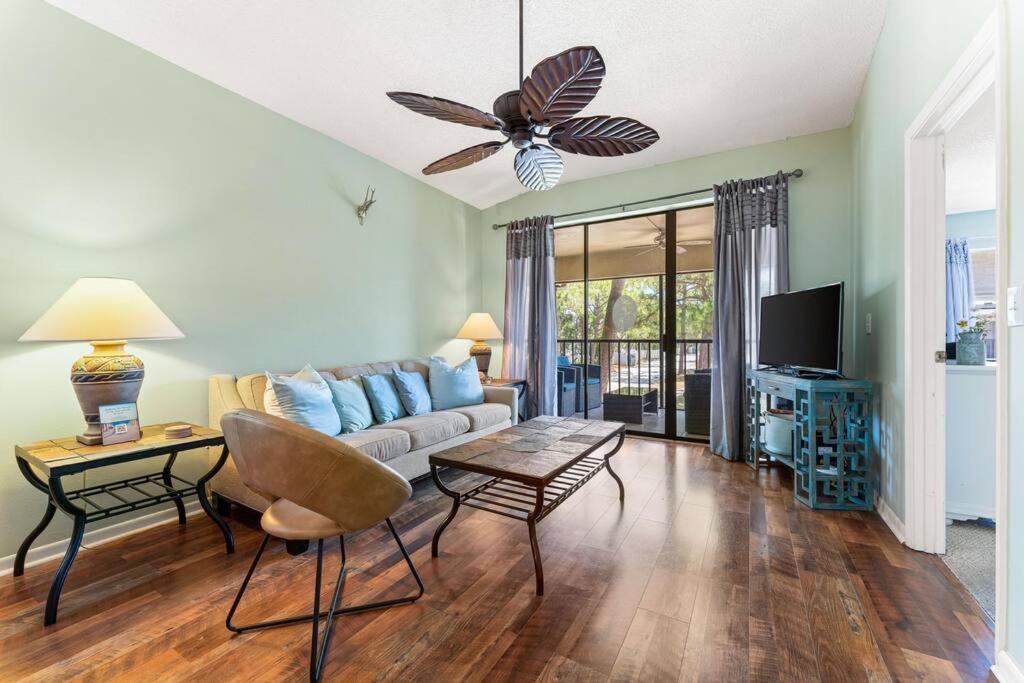 a living room with a couch and a tv at Stunning & Serene. Minutes to Anna Maria Island+++ in Bradenton