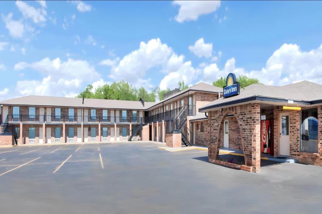 an empty parking lot in front of a building at Days Inn by Wyndham Erick in Erick