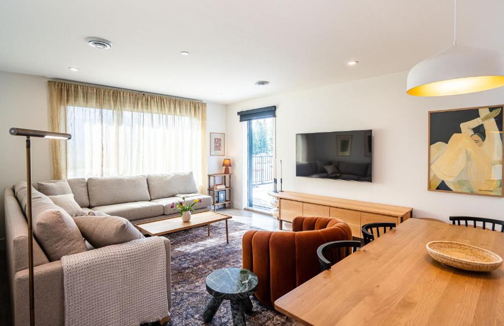 a living room with a couch and a table at Sea Eagles Landing by Revelstoke Vacations in Revelstoke