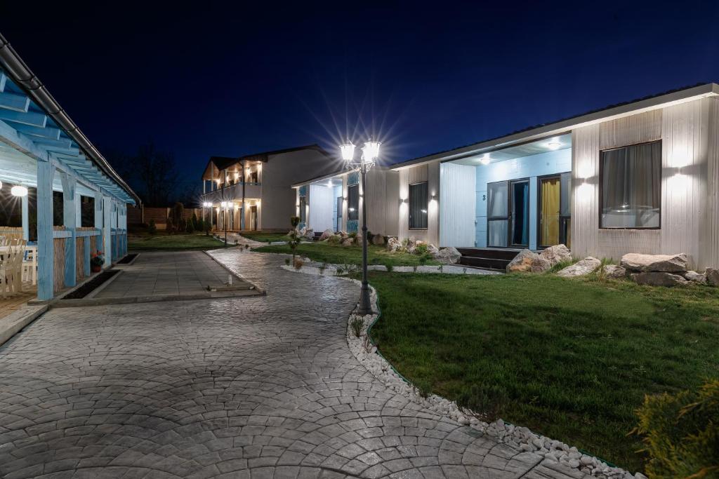 a street light next to a building at night at Delta Garden Resort in Dunavăţu de Jos