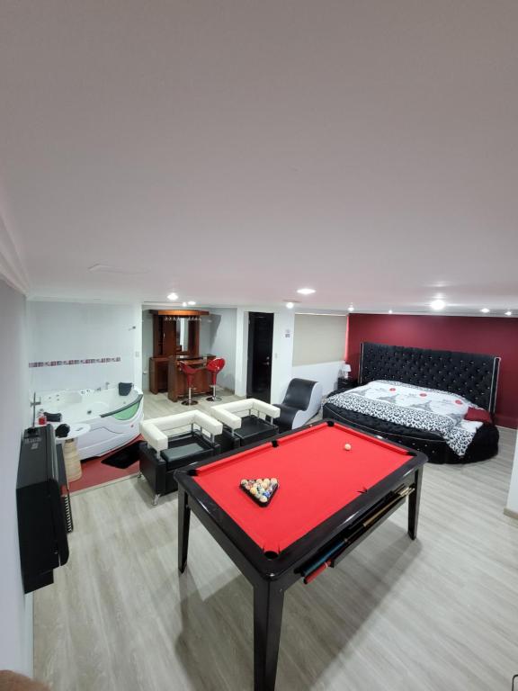 a living room with a red pool table in it at Departamento Duplex con Suite in Cuenca