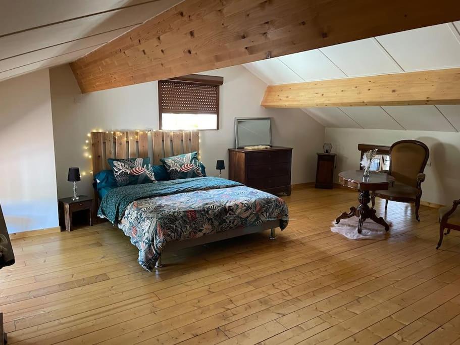a bedroom with a bed and a desk in a room at Maison de village le BACCI in Vals-les-Bains