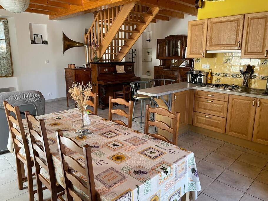 a kitchen with a table with a table cloth on it at Maison de village le BACCI in Vals-les-Bains