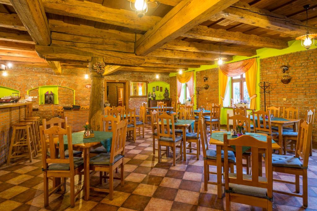 restauracja z drewnianymi stołami i krzesłami w pokoju w obiekcie Hotel Penzion Trámky w mieście Vikýřovice