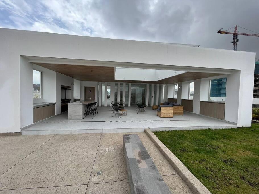 ein großes weißes Haus mit einer großen, offenen Terrasse in der Unterkunft Sky View Studio - Best Area Quito in Quito