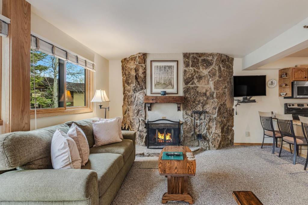 a living room with a couch and a fireplace at Laurelwood Condominiums 205 in Snowmass Village