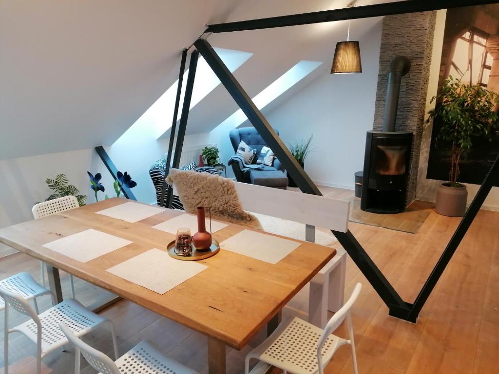a dining room with a table and chairs at Meisterhaus Apartment 8 in Glauchau