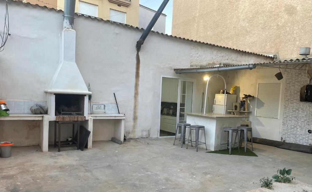 an outdoor kitchen with a counter and a stove at Apartamento con gran terraza in Mazarrón