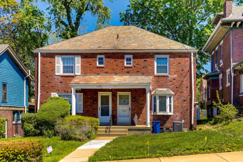 a brick house with a blue door at Peaceful Pittsburgh Townhome with Large Yard in Pittsburgh