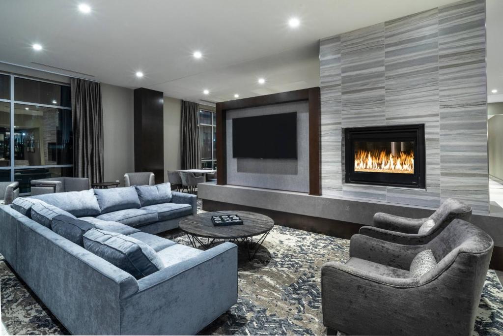 a living room with two couches and a fireplace at Fairfield Inn & Suites by Marriott Boston Logan Airport/Chelsea in Chelsea