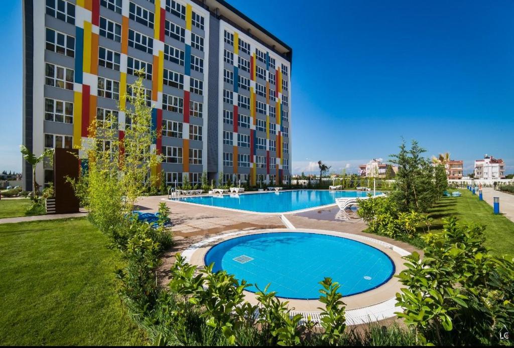a large apartment building with a large swimming pool at Antalya LEGOLAND COMPLEX Near the AIRPORT in Antalya