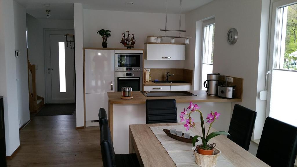 a kitchen with a table and a dining room at Kapitänshaus in Ueckeritz