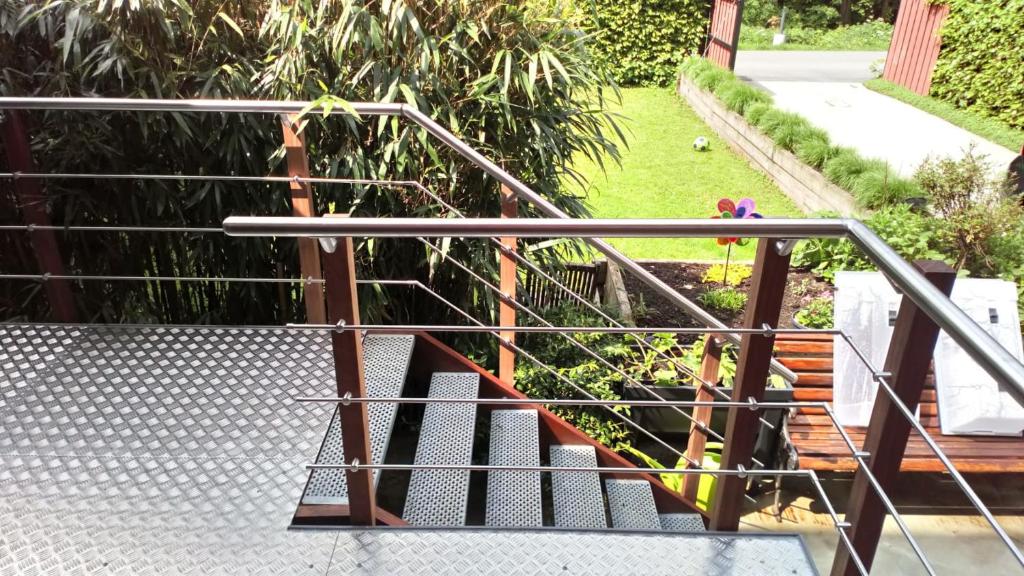 a set of stairs with a metal railing at The Séroule Park House in Verviers