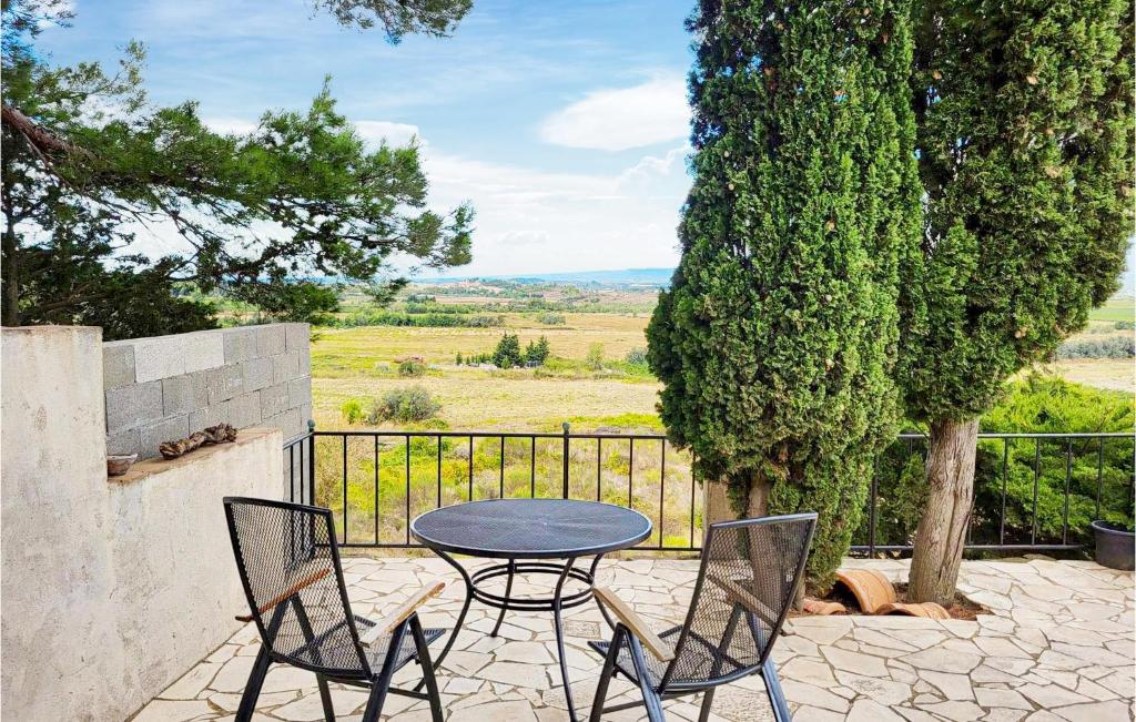 a table and chairs on a patio with a view at Nice Home In Escales With House A Panoramic View in Escales