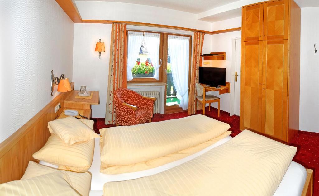Postel nebo postele na pokoji v ubytování Kurhotel Eichinger