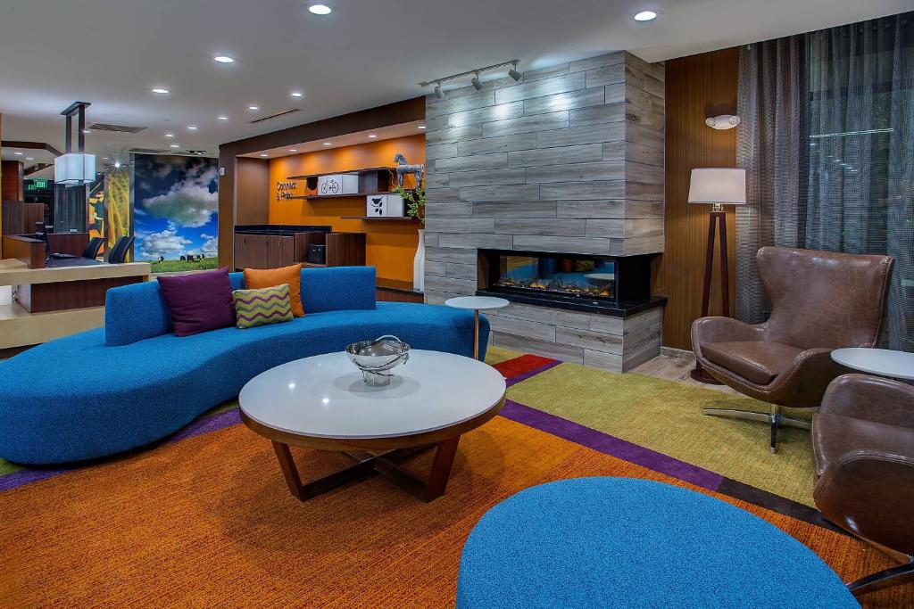 a living room with a blue couch and a fireplace at Fairfield Inn & Suites by Marriott Nashville Hendersonville in Hendersonville