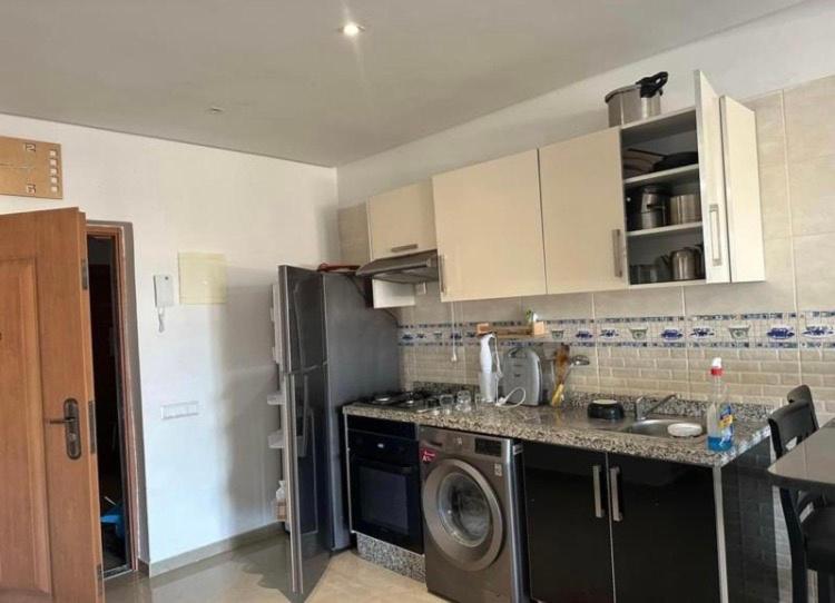 a kitchen with a refrigerator and a washing machine at Spacious 2-Bedroom Apartment in Martil