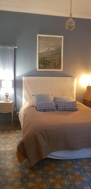 a bedroom with a bed with two pillows on it at Jolie maison de ville La Petite Magnanerie in La Roque-dʼAnthéron