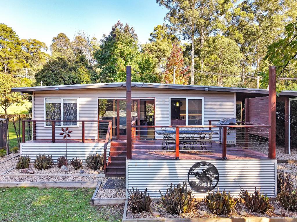 a manufactured home with a porch and a deck at Ren Basera in Mount Buller