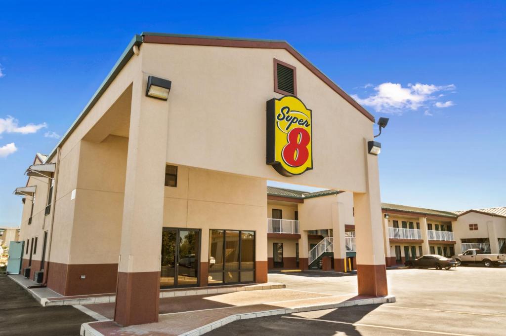 a mcdonalds building with a sign on it at Super 8 by Wyndham Hattiesburg North in Hattiesburg