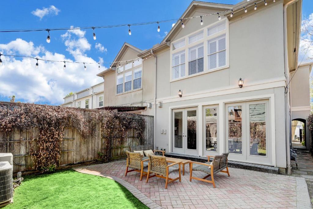 a home with a patio with a table and chairs at Spacious & Intimate Townhome near TMC/NRG Stadium/Rice Village in Houston