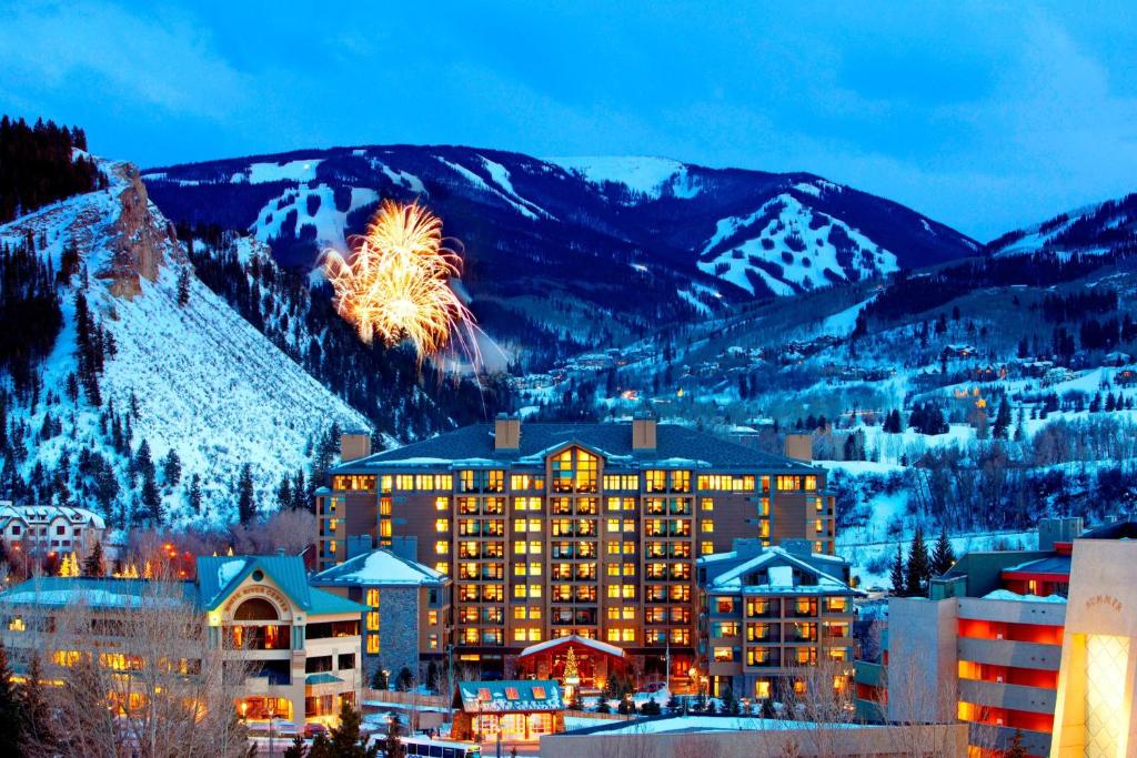 a hotel in the mountains with fireworks in the sky at The Westin Riverfront Resort & Spa, Avon, Vail Valley in Avon
