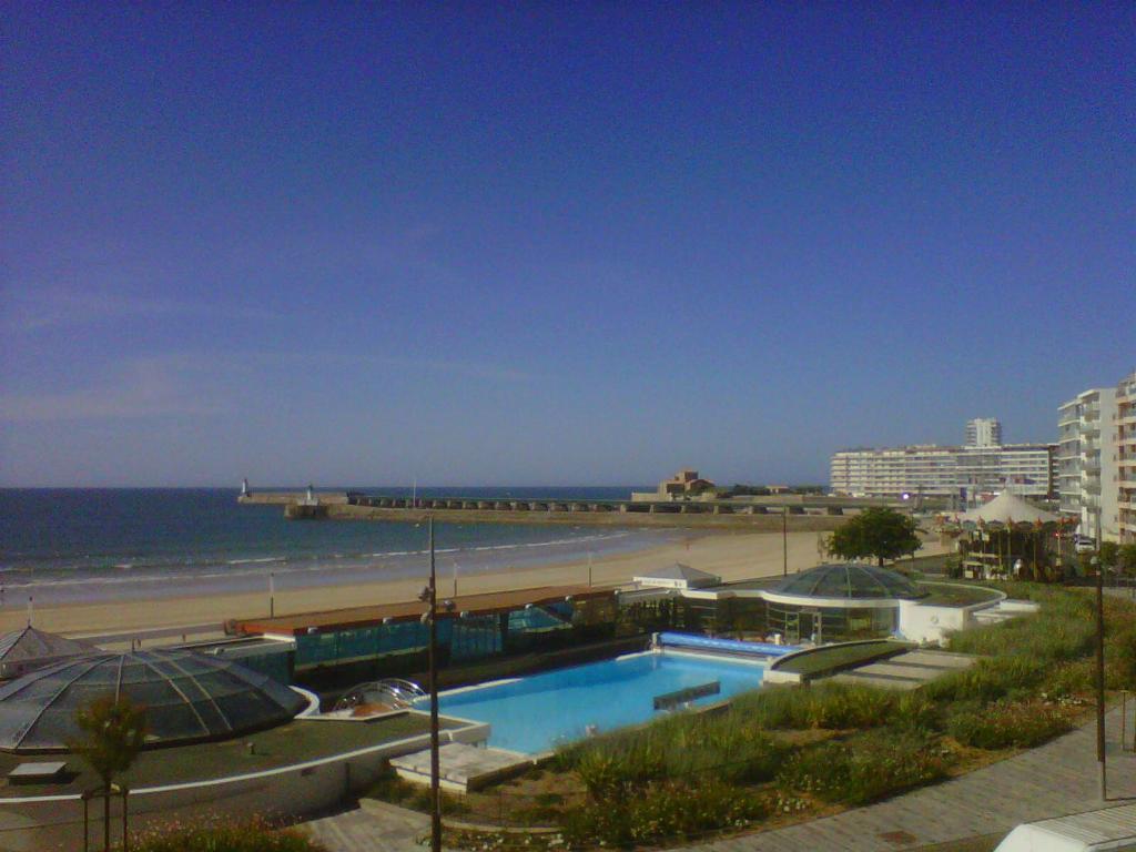 - une piscine à côté d'une plage et de l'océan dans l'établissement Studio Face Plage aux Sables d'Olonne avec Balcon, Ascenseur et Proximité Centre-Ville - FR-1-331-46, à Les Sables-dʼOlonne