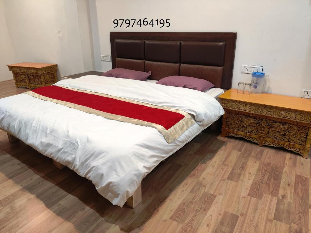 a bedroom with a large bed and a wooden table at Lynx near Leh airport in Leh