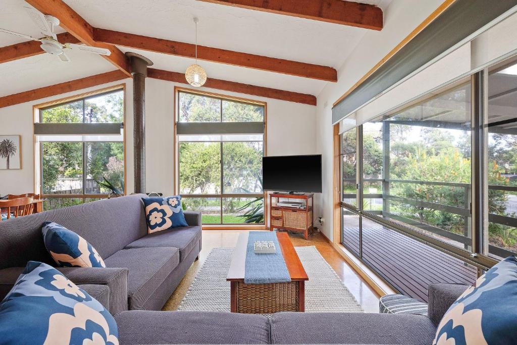 a living room with a couch and a tv at Plover Haven in Cowes