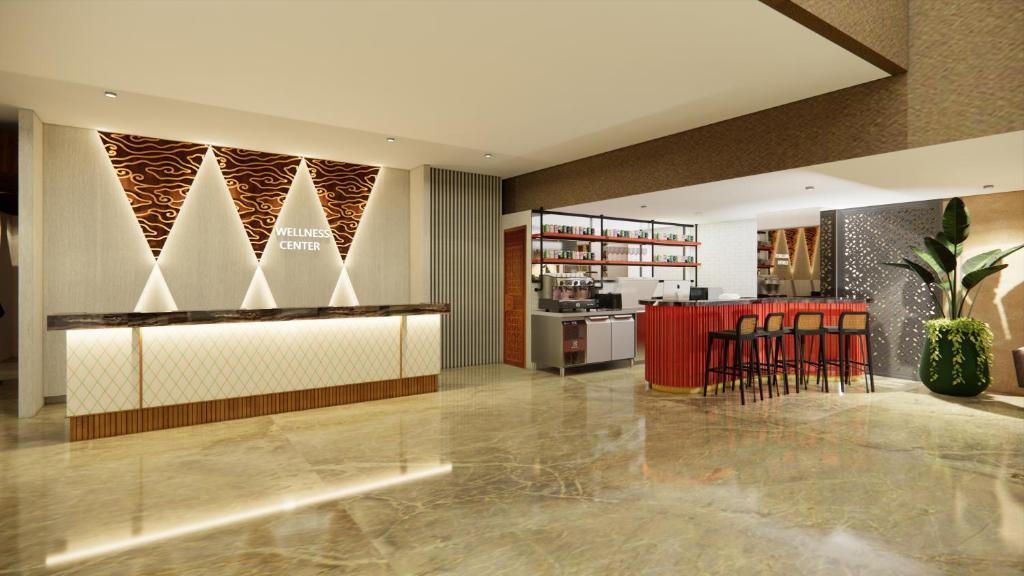 a lobby with a bar with chairs and a kitchen at d'primahotel Airport Jakarta Terminal 3 Wellness Center in Tangerang