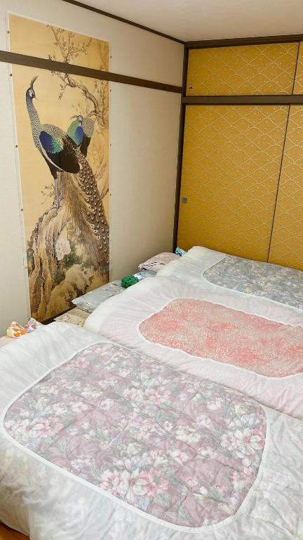 Postel nebo postele na pokoji v ubytování Kyoto Wakouan Retro Stay