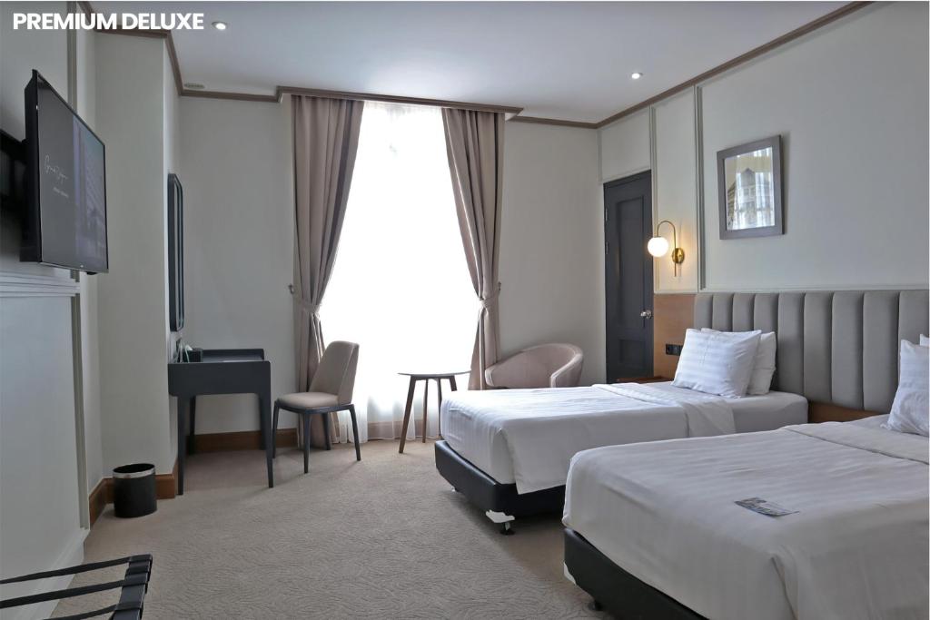 Postel nebo postele na pokoji v ubytování Hotel Dafam Semarang