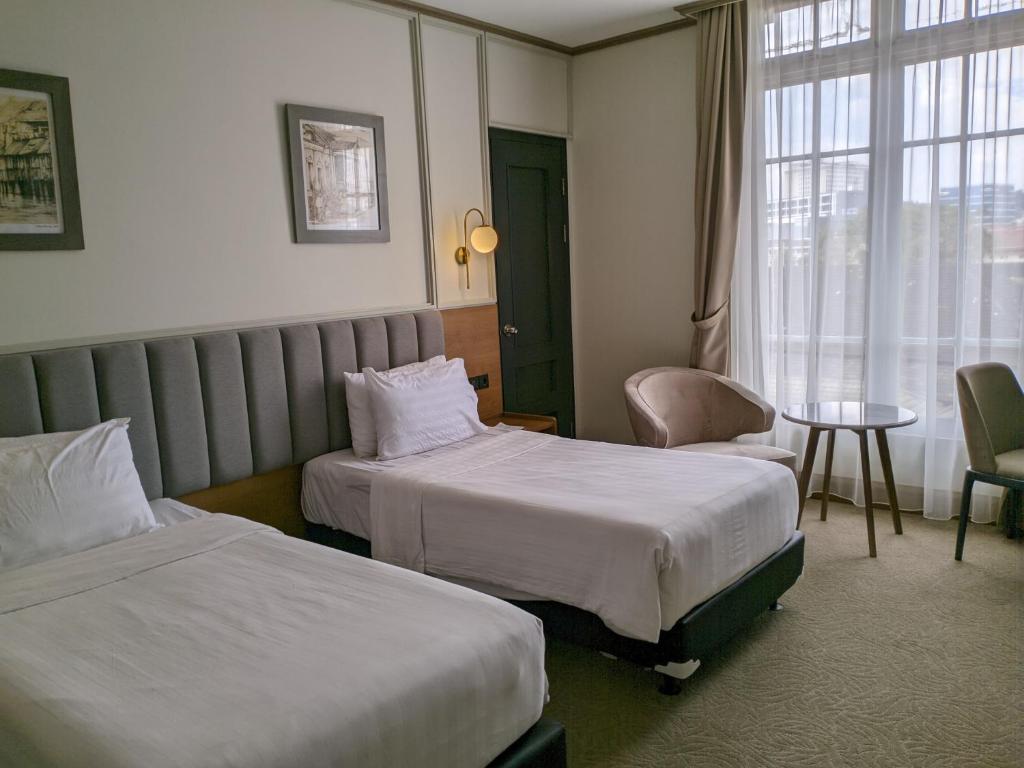 Postel nebo postele na pokoji v ubytování Hotel Dafam Semarang