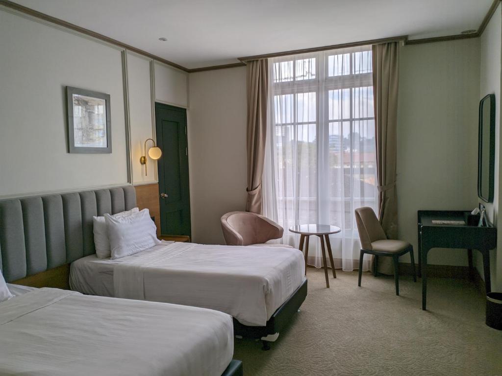 Postel nebo postele na pokoji v ubytování Hotel Dafam Semarang