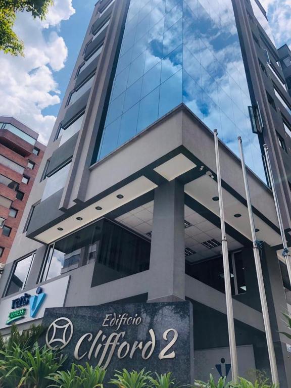 a building with a sign in front of it at Suite La Carolina QUITO in Quito