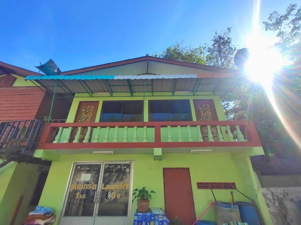 a house with a balcony on top of it at Talay Samed in Ko Samed