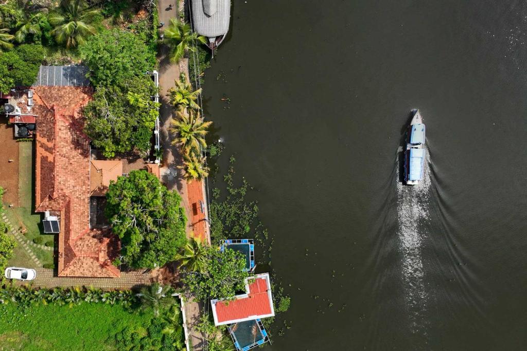 an aerial view of a boat in the water at The Backwater Heritage -Unwind on tranquil Alleppey backwaters in Alleppey