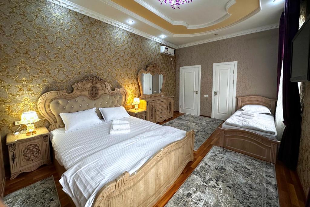 a bedroom with a large bed and a mirror at OLD STREET Guest House in Samarkand