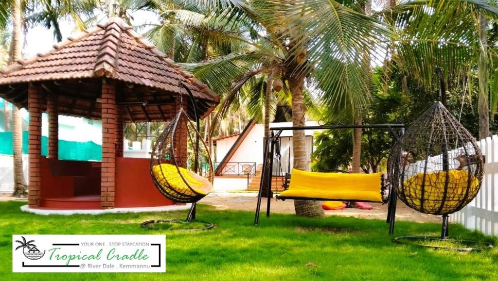 a swing set in a yard with a gazebo at Tropical Cradle @ River Dale in Kalyānpur