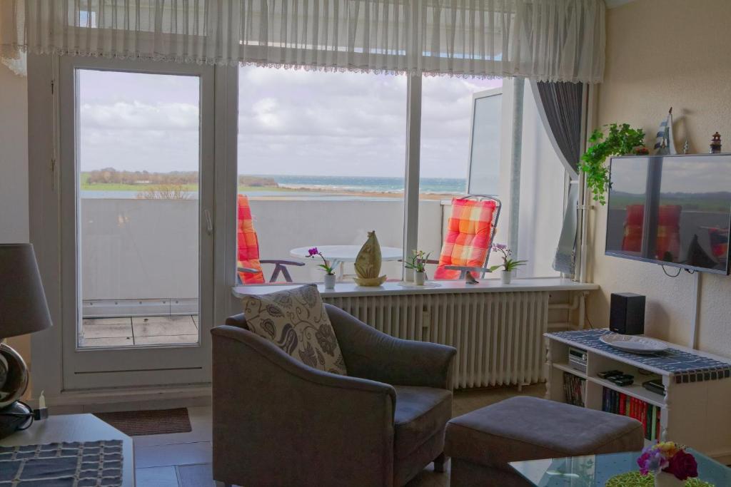 a living room with a view of the water at Appartement "Sonnenperle" in Heiligenhafen