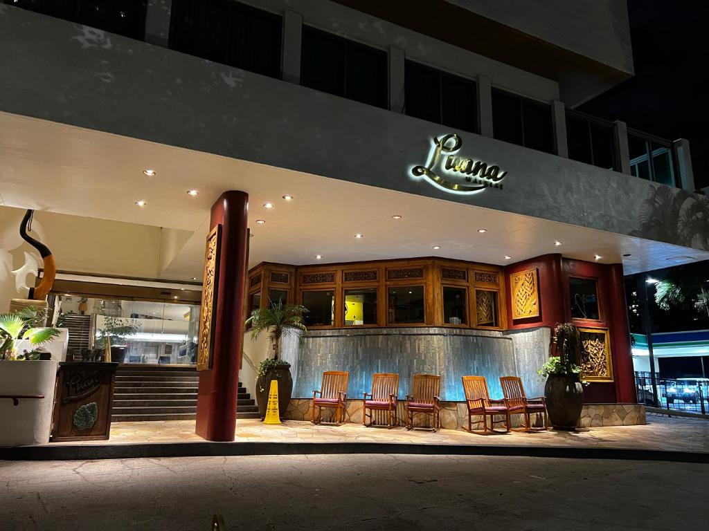 a restaurant with a bunch of chairs in front of it at Luana Waikiki Park Views in Honolulu