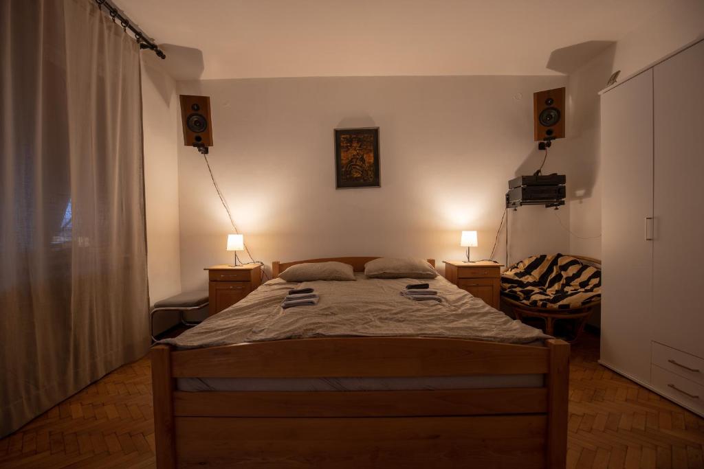 a bedroom with a bed and two lamps and a window at St Marks in Belgrade