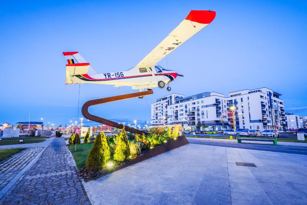 a small plane on a pole in a city at Lovely chic studio, on a beautiful promenade in Braşov