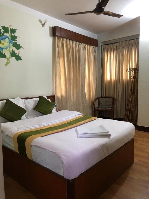 Postel nebo postele na pokoji v ubytování Bouddha Green Hotel