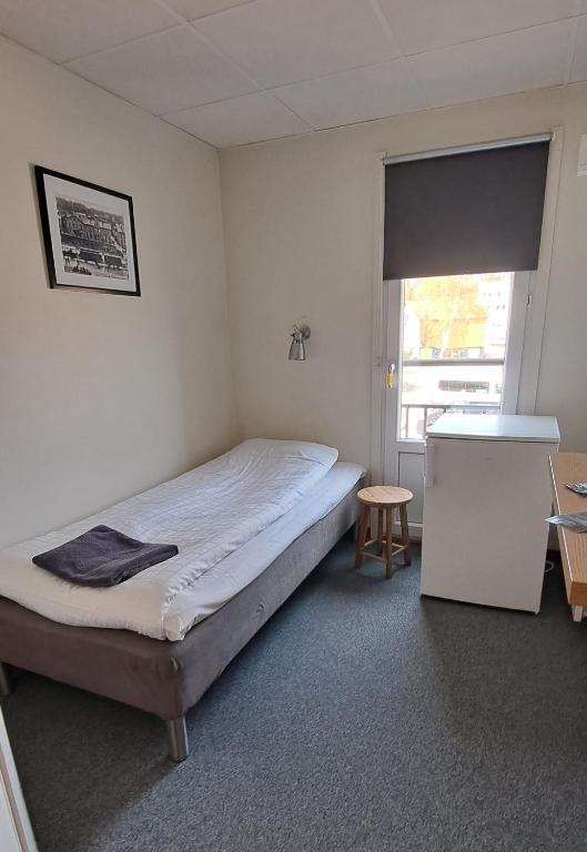 Postel nebo postele na pokoji v ubytování Kramfors Stadshotell AB