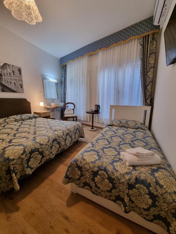 Postel nebo postele na pokoji v ubytování Albergo Casa Peron