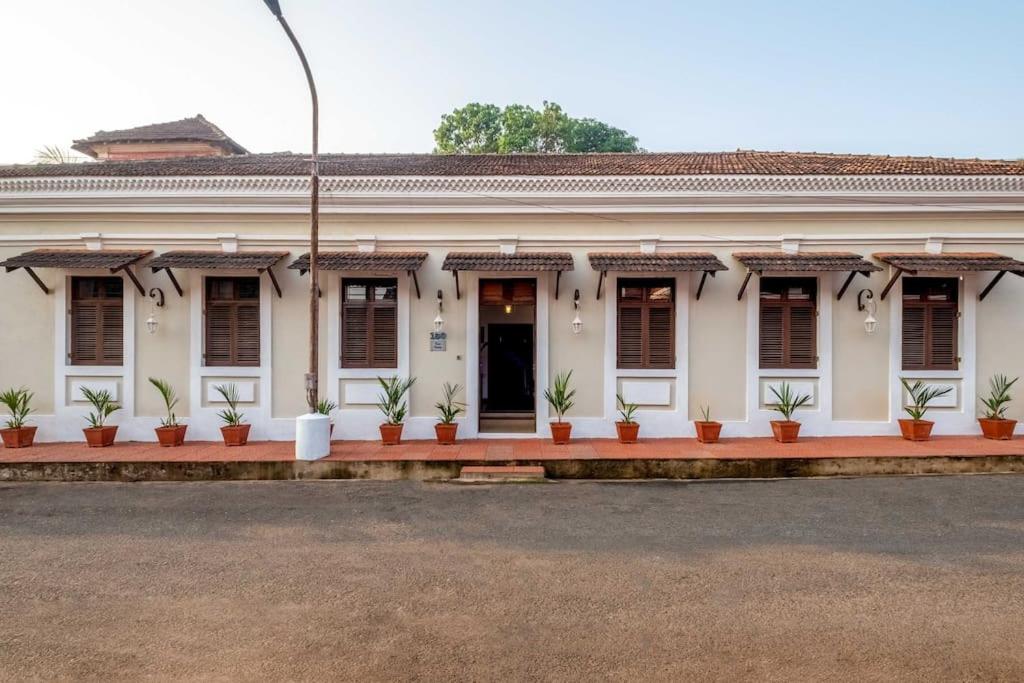 a white building with plants inront of it at Nyara Fontainhas Panaji - Heritage villa Goa in Panaji