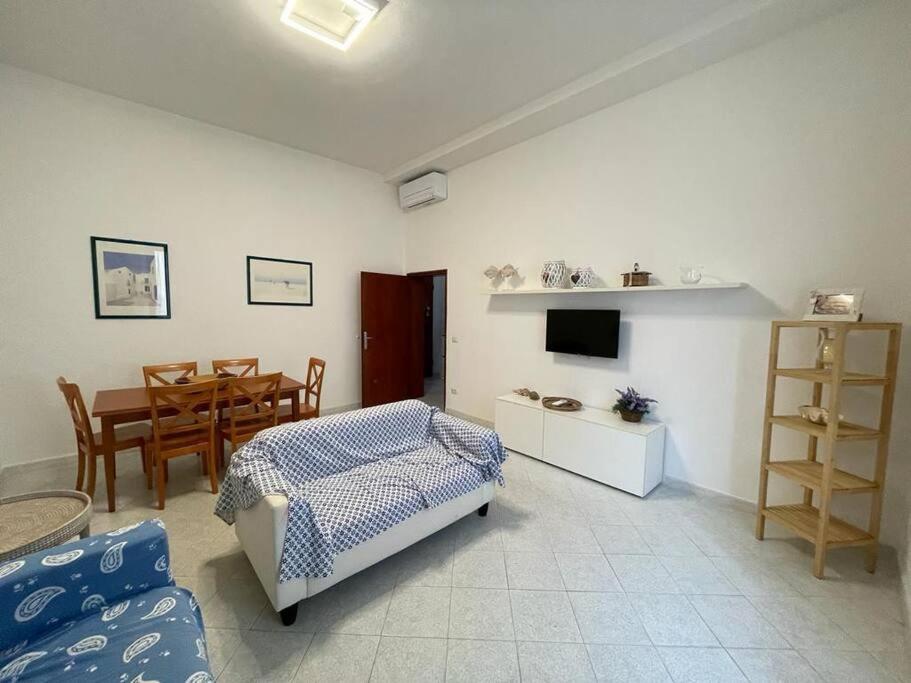a living room with a bed and a dining room at A due passi dal Mare in Castiglione della Pescaia