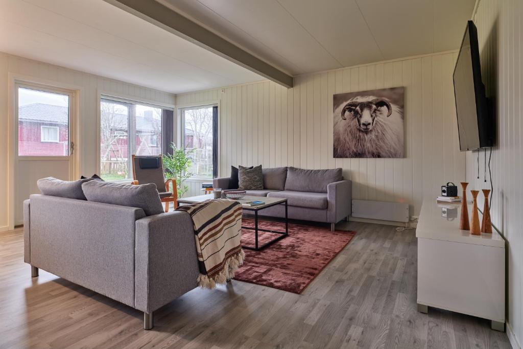 a living room with two couches and a tv at Perfekt base for det meste! in Leknes